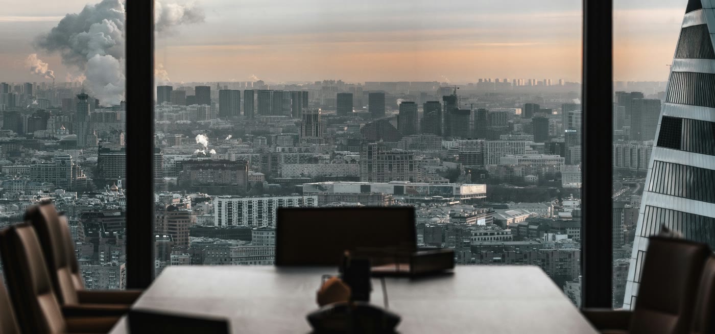 Due diligence and corporate deals: an executive boardroom overlooking a financial district at dusk